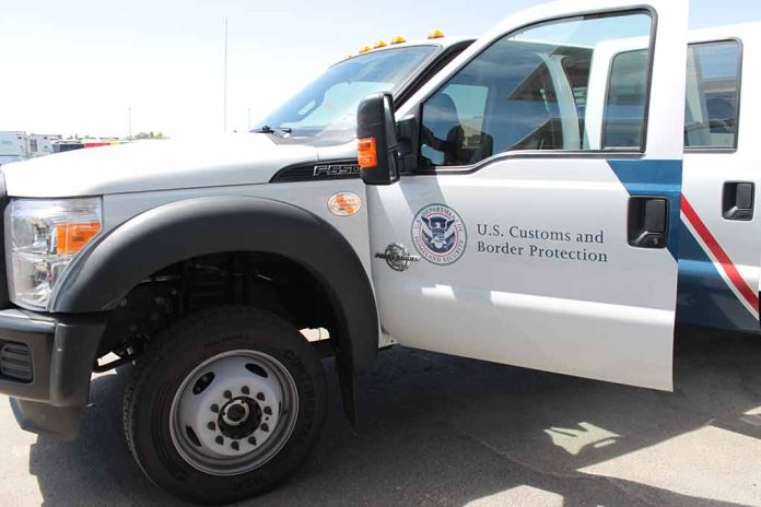 U.S. Customs and Border Protection truck with open door.