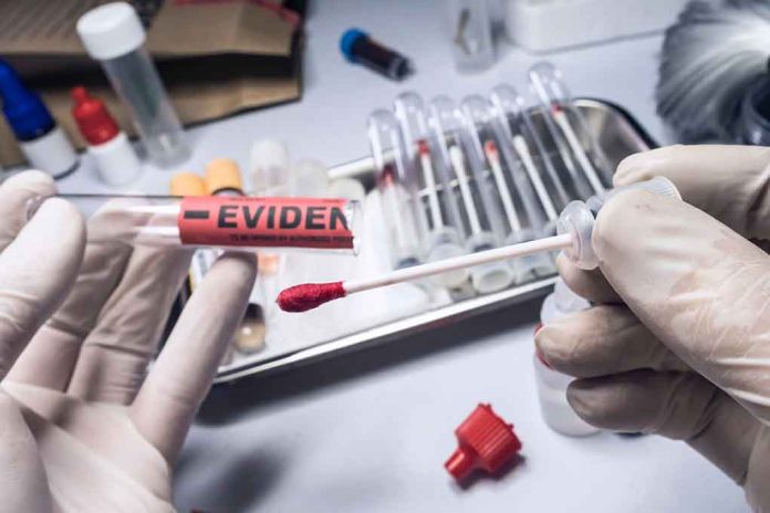 Gloved hands holding evidence tube and cotton swab.