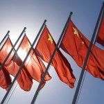Red flags with yellow stars on flagpoles.