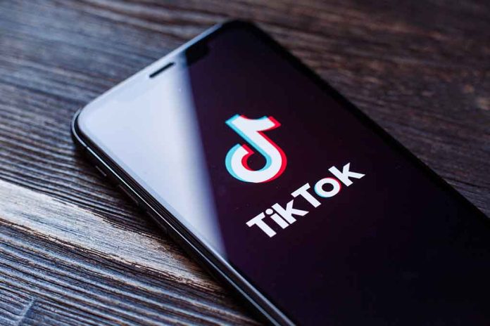 Phone screen showing TikTok logo and app.