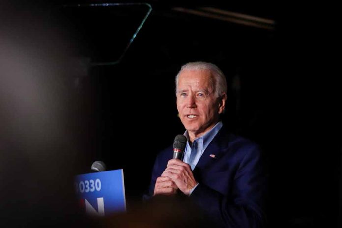 Man speaking into a microphone on stage.