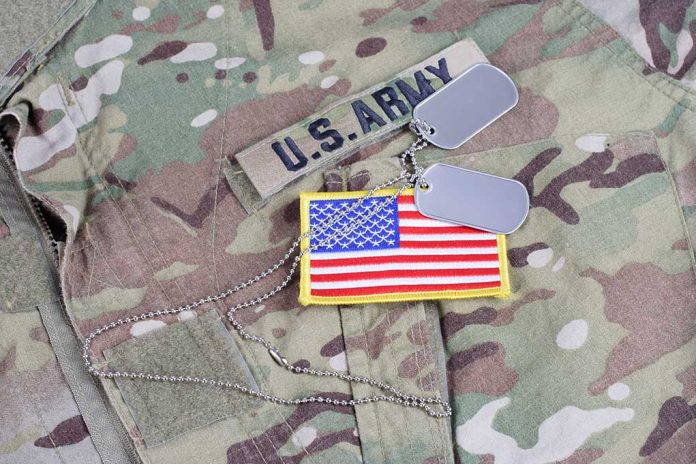 U.S. Army uniform with dog tags and American flag.