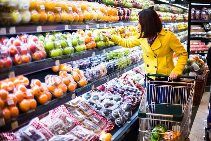 Woman shopping for fruit in a grocery store.