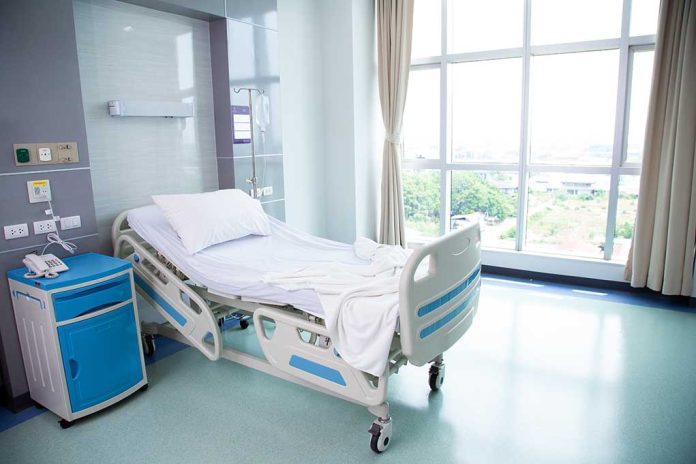 Empty hospital room with a single bed.