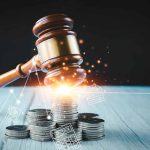 Gavel, coins, and tax icons on a table.
