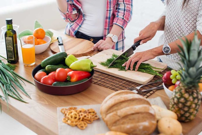 People preparing fresh vegetables in kitchen.