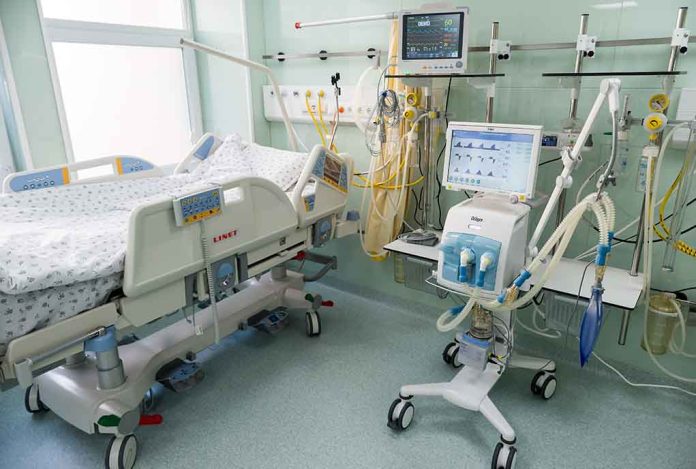 Hospital bed in ICU with monitoring equipment.