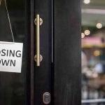 "Closing Down" sign on a shop door.