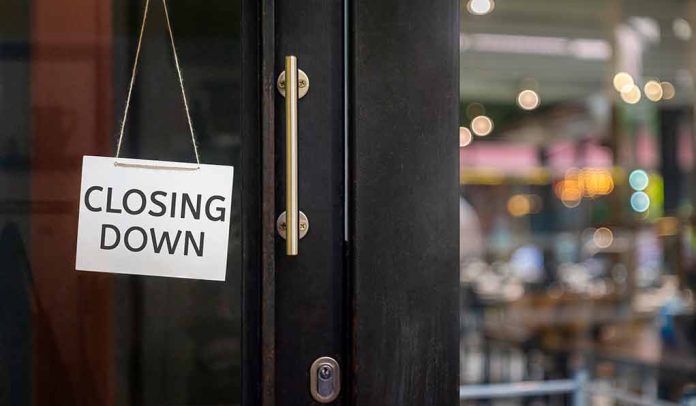 "Closing Down" sign on a shop door.