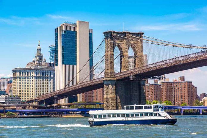 Boat passing under Brooklyn Bridge in New York.