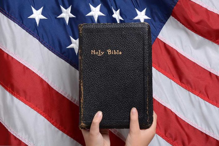 Bible held in front of American flag.