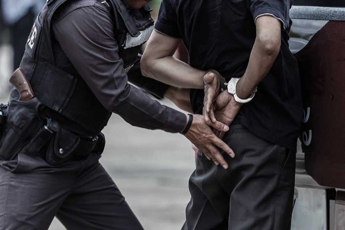 Police officer arresting a person.