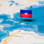 Haitian flag placed on a map of the Caribbean.