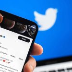 Person viewing Elon Musk's Twitter profile on smartphone.