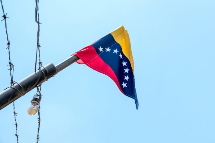 Venezuelan flag flying on a pole.