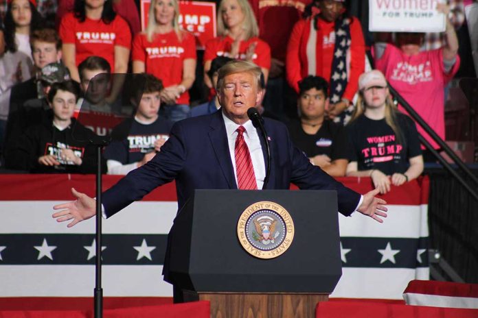 Person speaking at podium with crowd behind them.