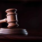 Wooden gavel on a dark background.
