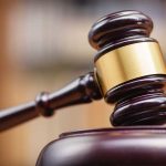 Wooden gavel on sound block courtroom setting