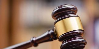 Wooden gavel on sound block courtroom setting
