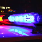 Police car lights flashing red and blue.