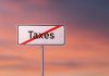Sign with the word Taxes crossed out