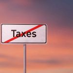 Sign with the word Taxes crossed out