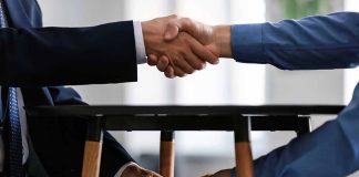 Handshake above table money exchange below table
