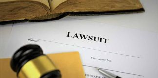 Lawsuit document with gavel pen and open book