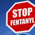 Stop sign saying Stop Fentanyl against sky