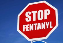Stop sign saying Stop Fentanyl against sky