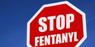 Stop sign saying Stop Fentanyl against sky