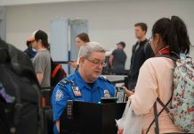TSA agent checks passenger documents at airport security