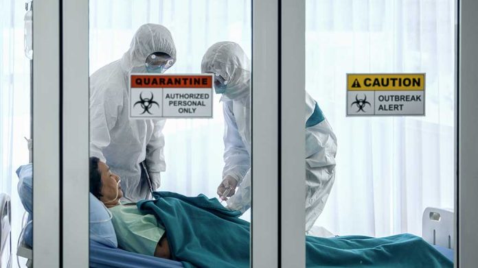 1647350797 featured image Healthcare workers in protective gear in quarantine room