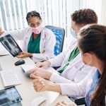 Doctors discussing chest Xray results at a workstation