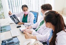 Doctors discussing chest Xray results at a workstation