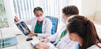 Doctors discussing chest Xray results at a workstation