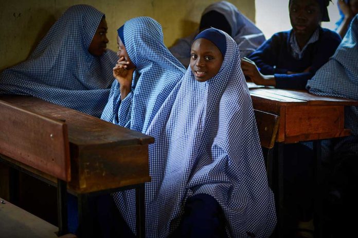 1852864039 featured image Girls in checkered hijabs sitting at school desks