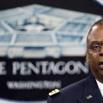 Man speaking in front of Pentagon sign