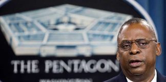 Man speaking in front of Pentagon sign