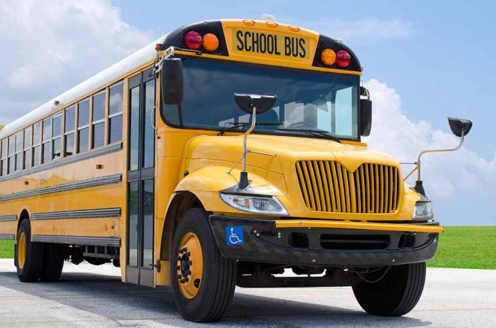 271198973 featured image Yellow school bus parked on pavement under blue sky