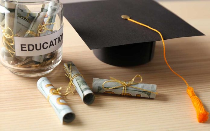 559683955 featured image Graduation cap with money rolls and jar labeled Education