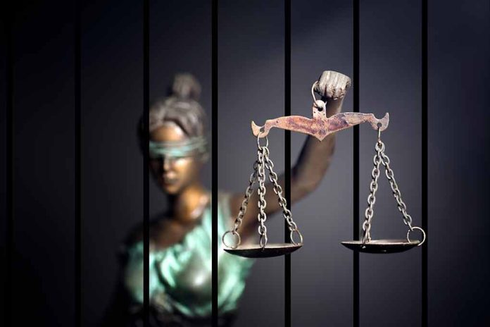 562957564 featured image Blindfolded Lady Justice statue holding scales behind bars