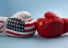 USA and China boxing gloves facing each other