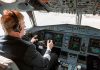 Pilot in cockpit operating airplane controls