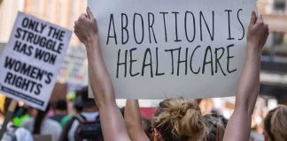 Protestors holding signs about women's rights and healthcare