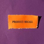 Product Recall text on orange paper purple background