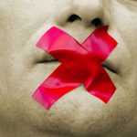 Man with red tape over mouth