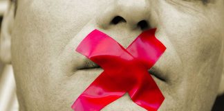 Man with red tape over mouth