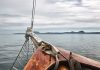 Boat deck with ropes on calm ocean water