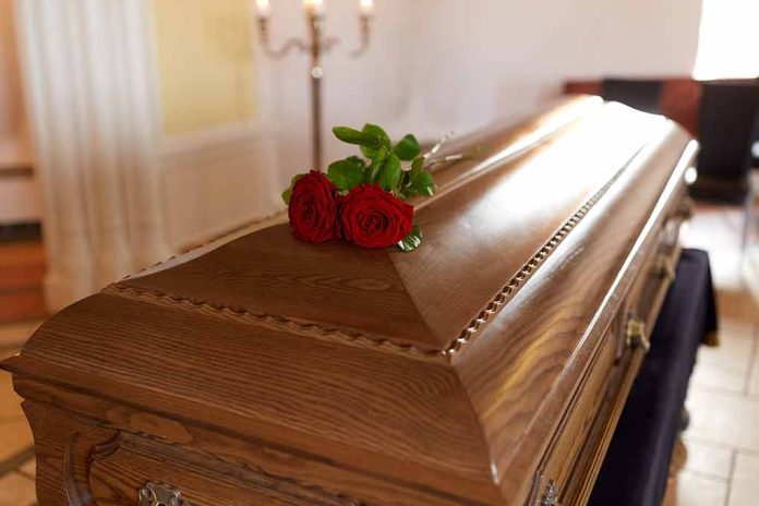 664198003 featured image Wooden casket with red roses on top